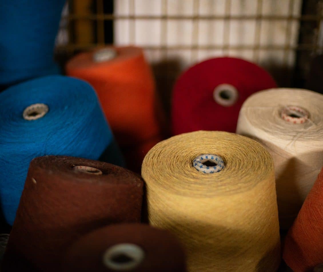 Spools spools of recycled yarn in factory crate