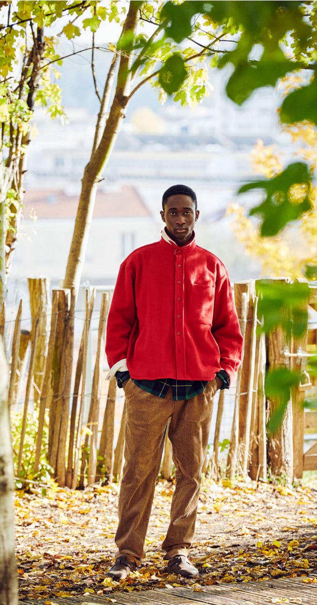 Man in park in the red LATER 03 oversized overshirt